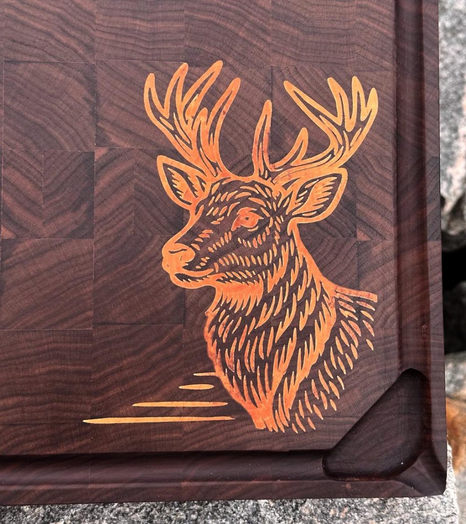 Skjærefjøl i valnøtt med innlagt motiv i bjørk